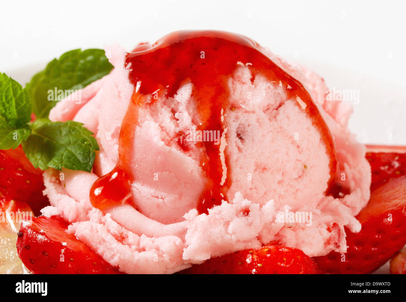 Scoop of pink ice cream with fresh strawberries Stock Photo