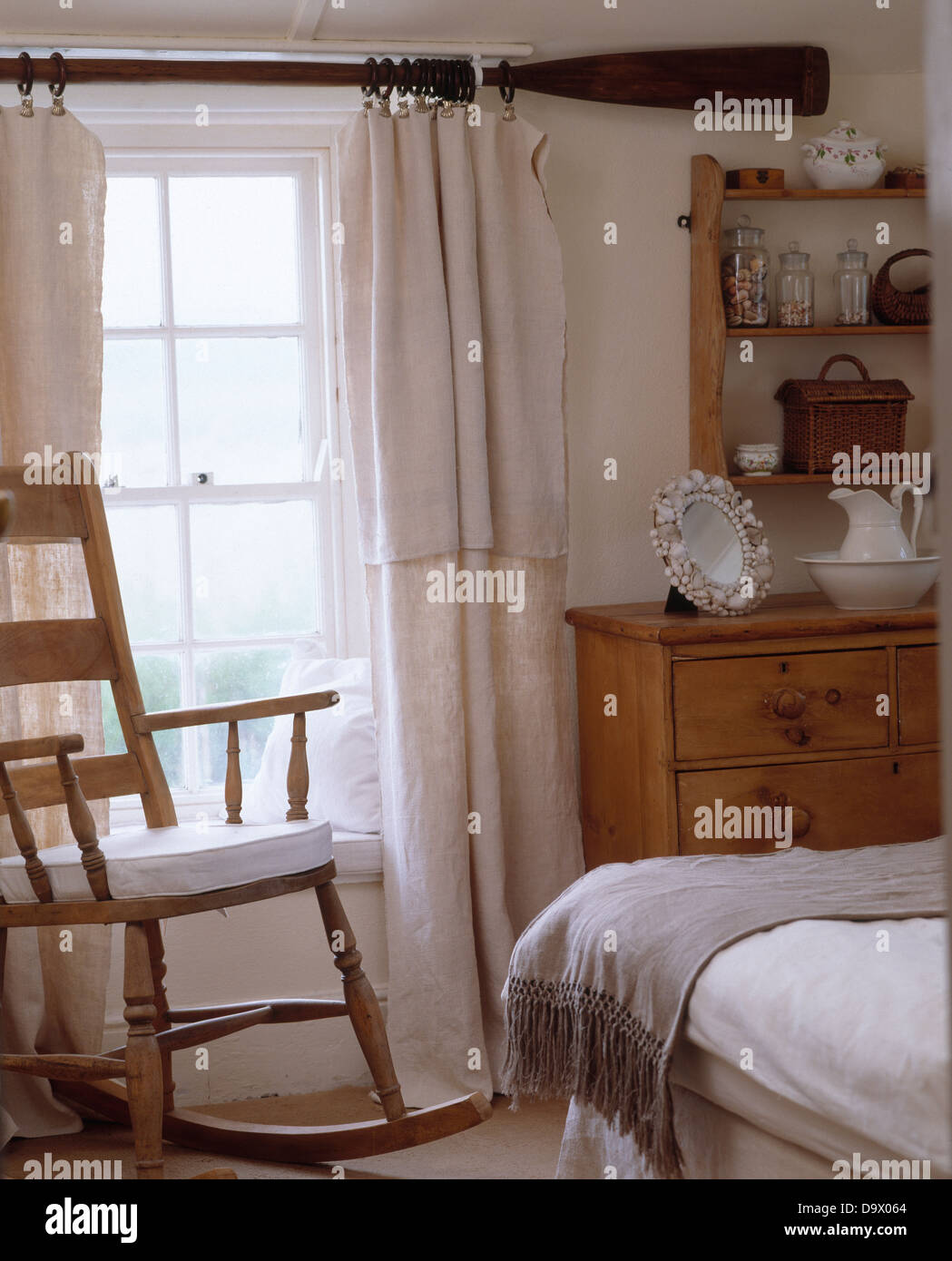 Rocking Chair In Front Of Window With Old Oar Used As Curtain Rod