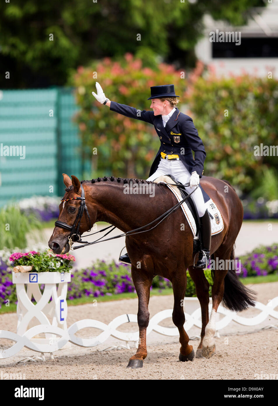 German equestrian Helen Langehanenberg waves on her horse Damon Hill