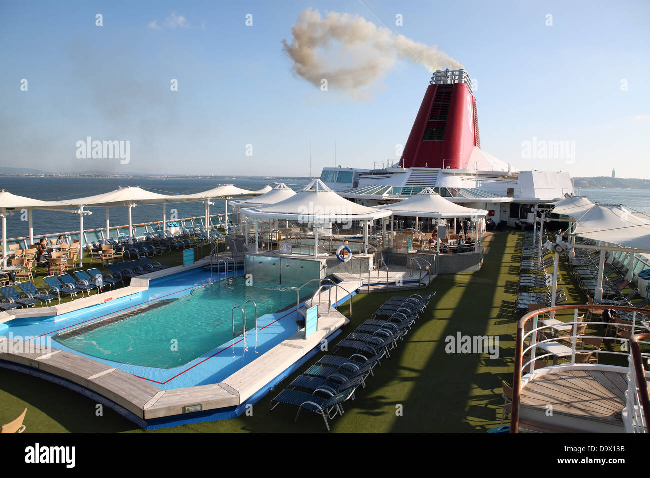 Upper main deck Cruise ship swimming pool safety boat ocean Stock Photo