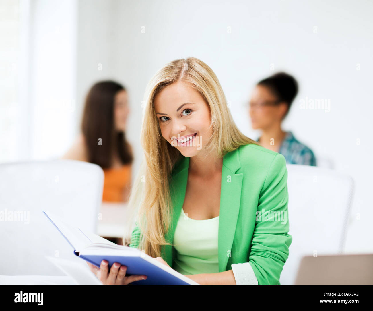 smiling student girl reading book at school Stock Photo - Alamy