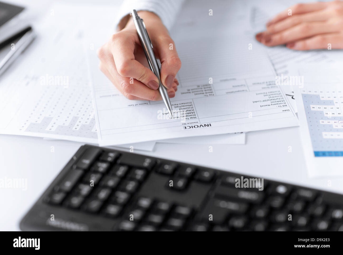 woman hand filling in invoice paper Stock Photo