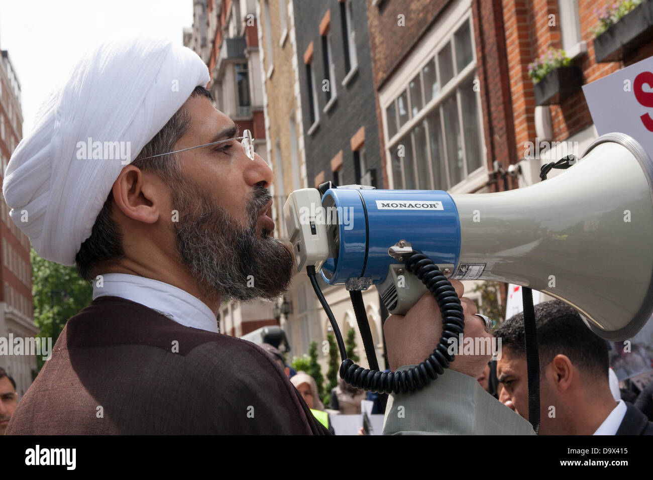 London, UK. 27th June 2013. An Iman makes a speech to the assembled crowd outside the Egyptian embassy  as Egyptians in London protest against sectarian killings in Egypt. Credit:  Paul Davey/Alamy Live News Stock Photo