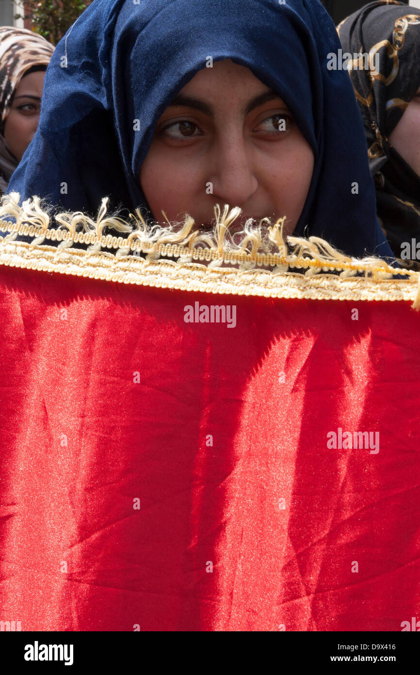 London, UK. 27th June 2013. A woman holds up her end of the Egyptian flag as Egyptians in London protest against sectarian killings in Egypt. Credit:  Paul Davey/Alamy Live News Stock Photo