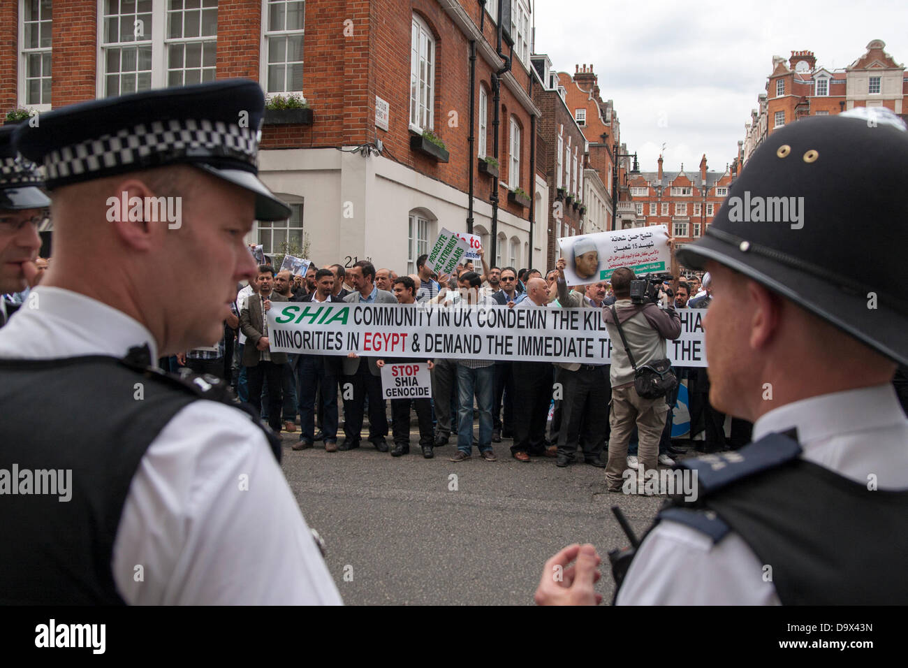 London, UK. 27th June 2013. Police officers look on as Egyptians in London protest against sectarian killings in Egypt. Credit:  Paul Davey/Alamy Live News Stock Photo