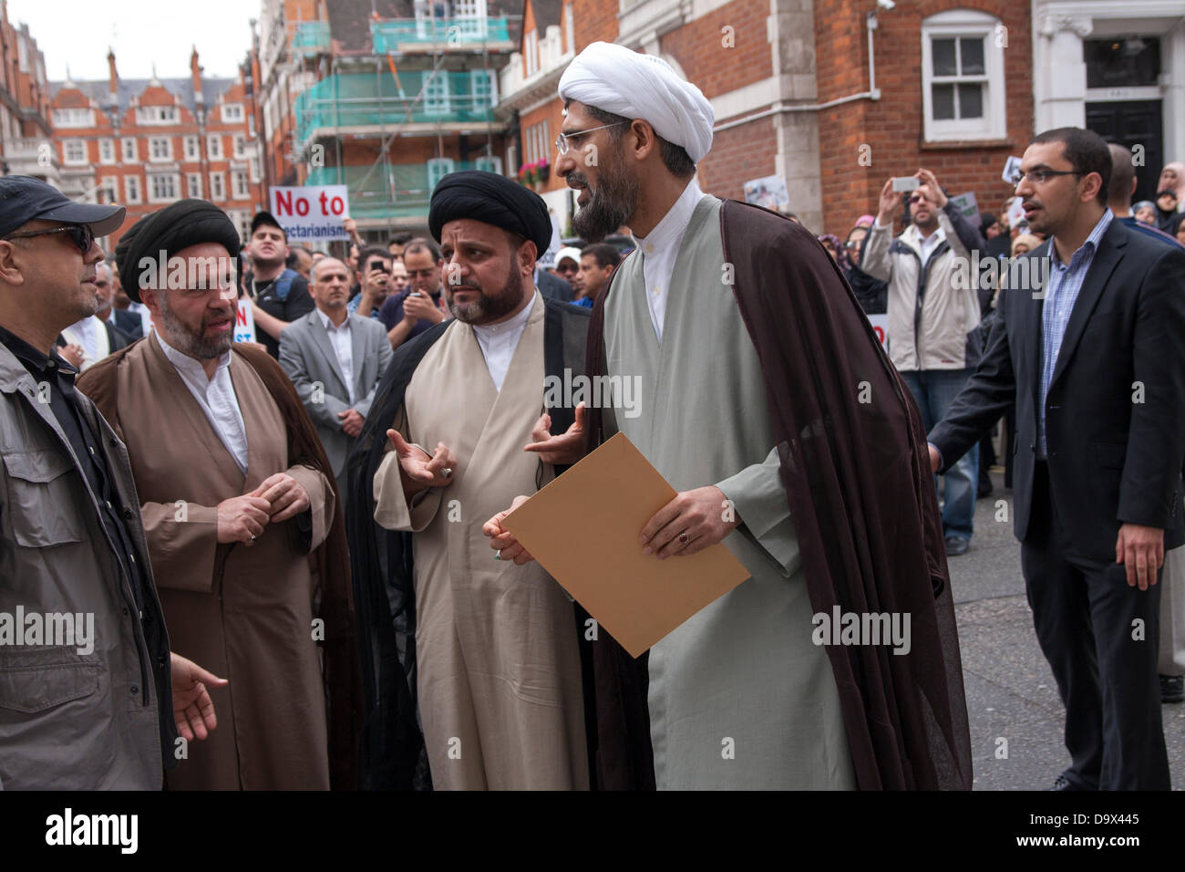 London, UK. 27th June 2013. A Muslim cleric prepares to enter the Egyptian embassy to deliver a letter to the Ambassador as Egyptians in London protest against sectarian killings in Egypt. Credit:  Paul Davey/Alamy Live News Stock Photo