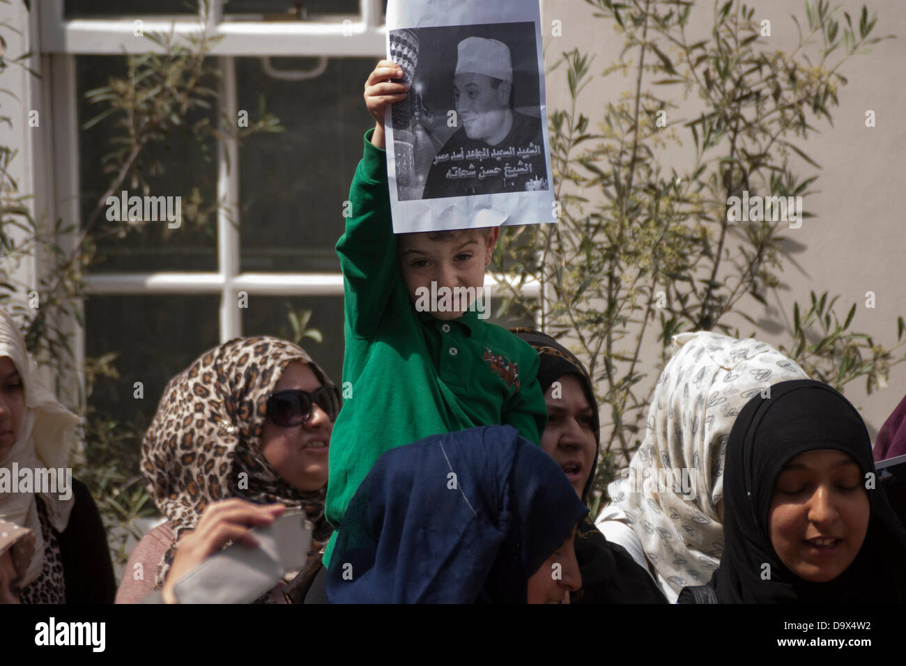 London, UK. 27th June 2013. A small child sits on his mother's shoulders as Egyptians in London protest against sectarian killings in Egypt. Credit:  Paul Davey/Alamy Live News Stock Photo