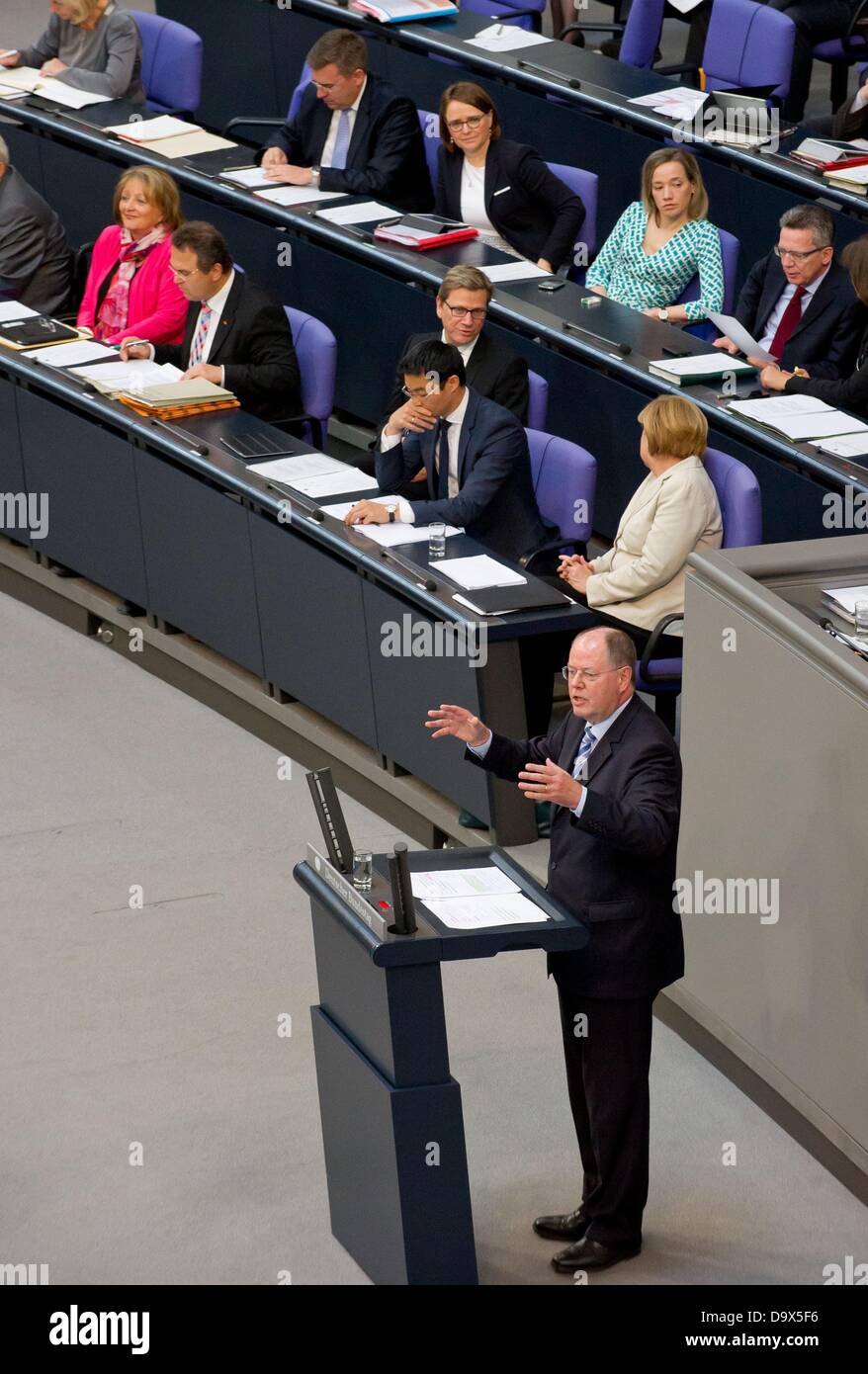 The SPD's candidate for the office of German Chancellor, Peer Steinbrueck, delivers a speech in response to the government policy statement of German Chancellor Angela Merkel (CDU, middle row, R) on the recent G8 summit and the forthcoming EU summit during a parliamentary debate in the Bundestag in Berlin, Germany, 27 June 2013. Photo: Tim Brakemeier Stock Photo