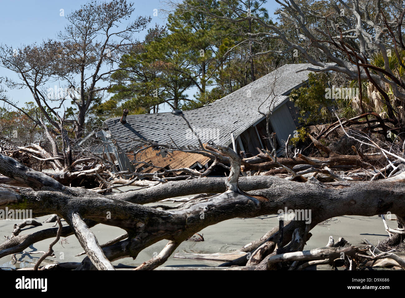 house destroyed by flood surrounded by driftwood. Stock Photo