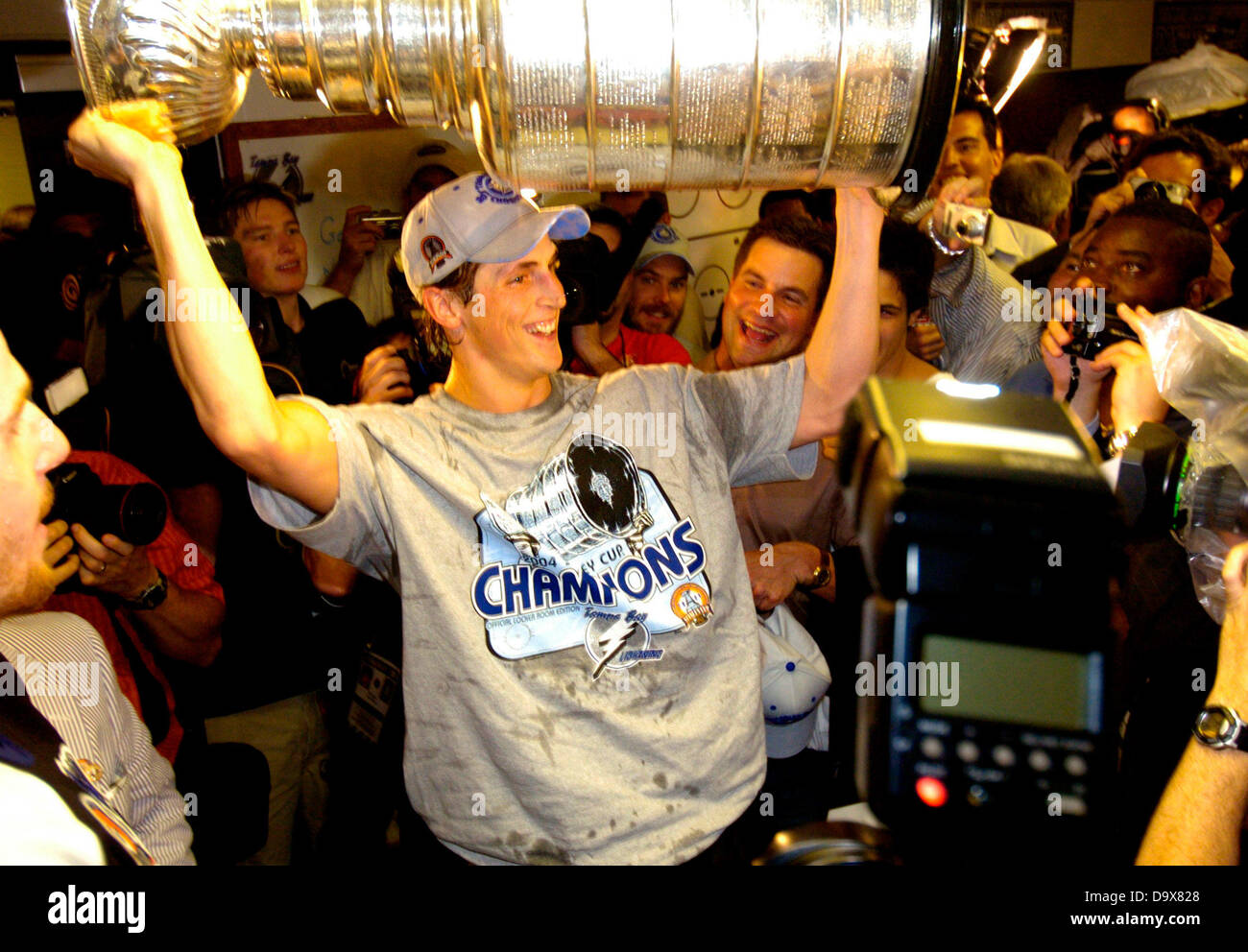 June 7, 2004 - Tampa, Florida, U.S. - DIRK SHADD   |   Times  .Tampa Bay Lightning Vinny Lecavalier hoists the Stanley Cup in the locker room after beating the Calgary Flames in game seven of the Stanley Cup Final at the St. Pete Times Forum on 6/7/04. The Tampa Bay Lightning will use its compliance buyout on captain Vinny Lecavalier, ending a relationship with the player who has been an iconic community figure since he was the No. 1 overall pick of the 1998 draft. He will be a free agent as of July 5, able to sign with any team except Tampa Bay. (Credit Image: © Dirk Shadd/Tampa Bay Times/ZUM Stock Photo