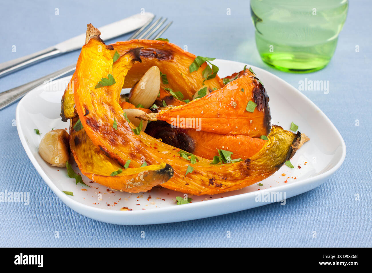 Oven roasted pumpkin slices on plate Stock Photo