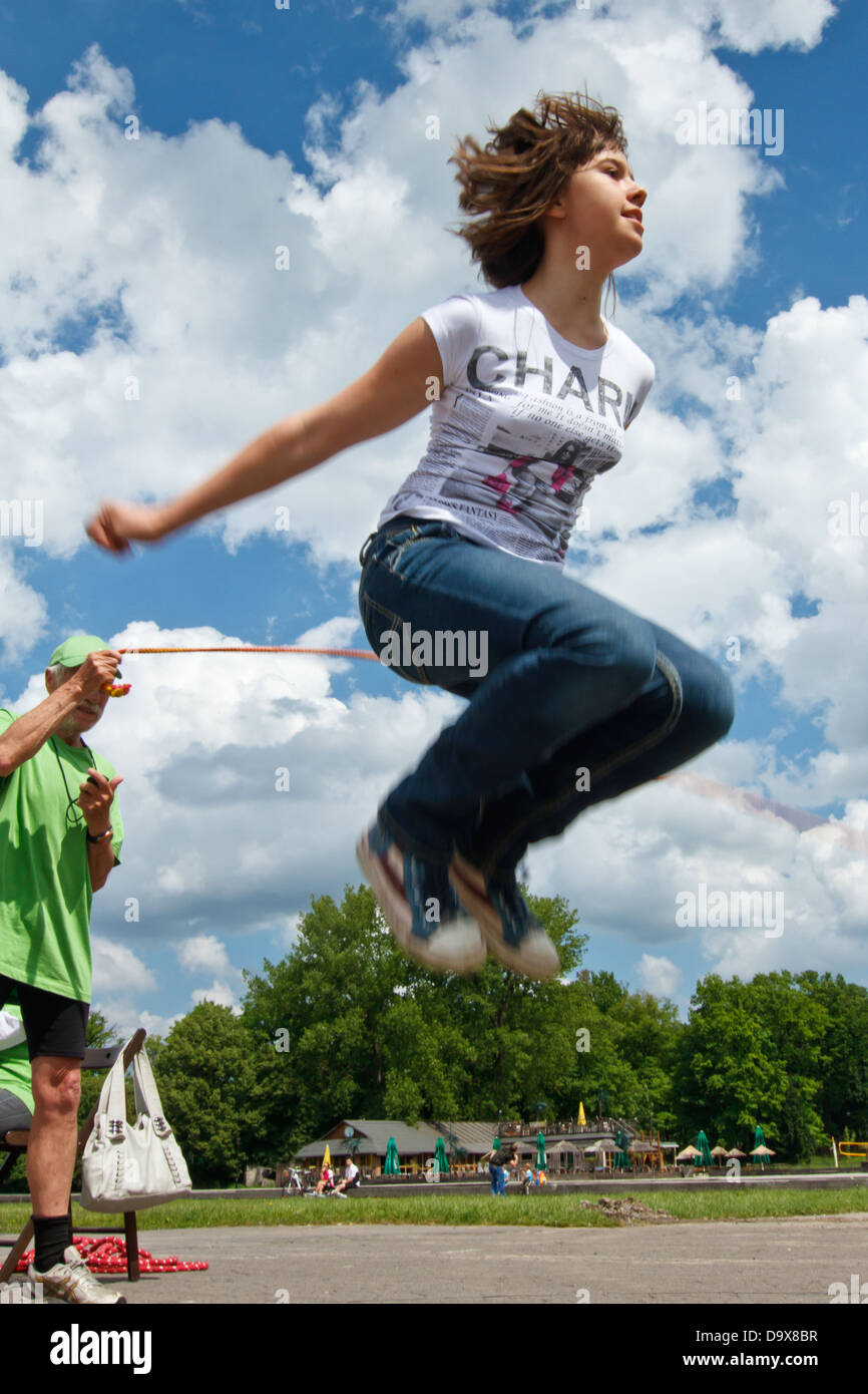 Girl jumping over a skipping rope Stock Photo - Alamy