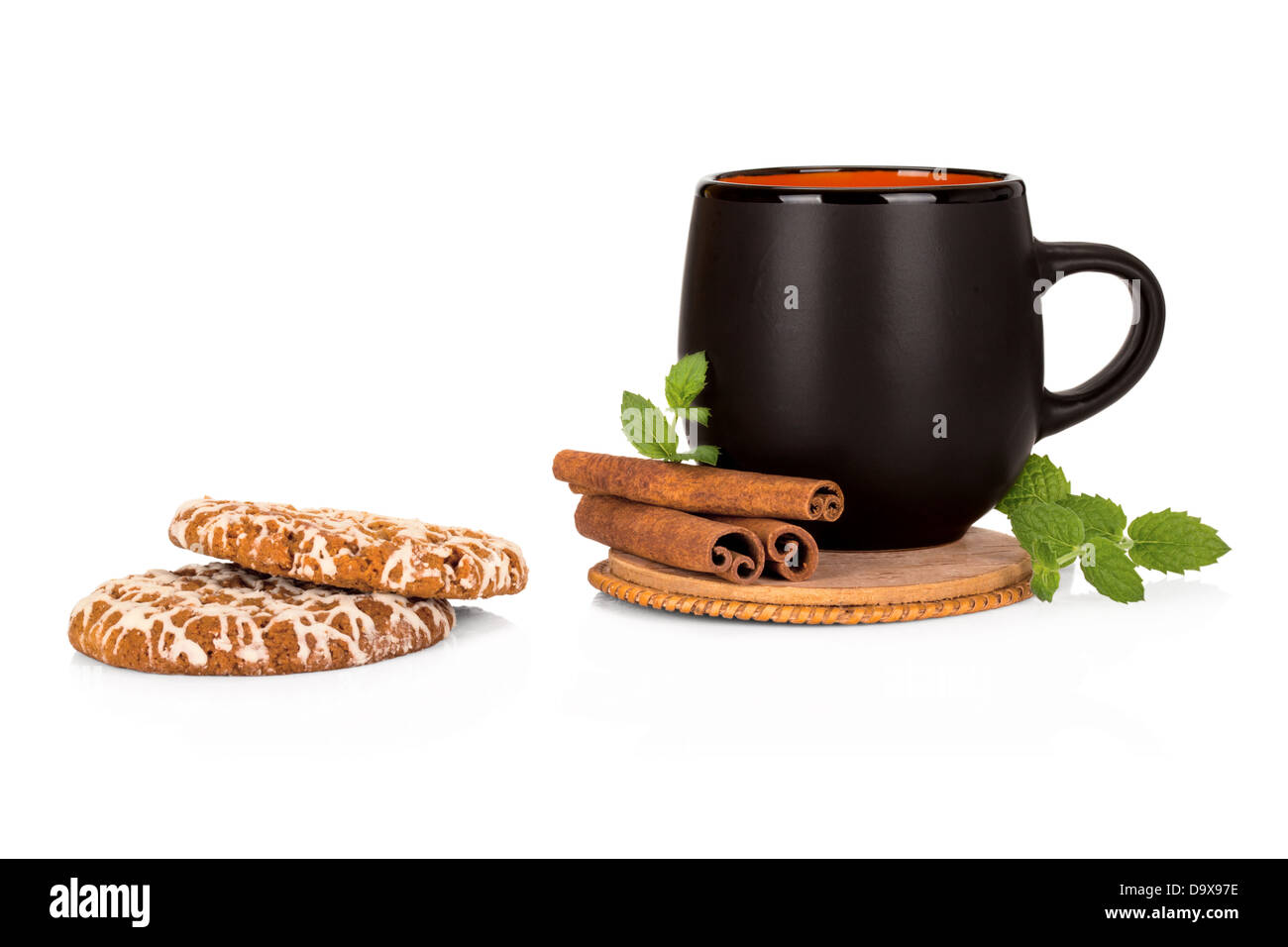 Black tea cup with cinnamon and cookies on white background Stock Photo