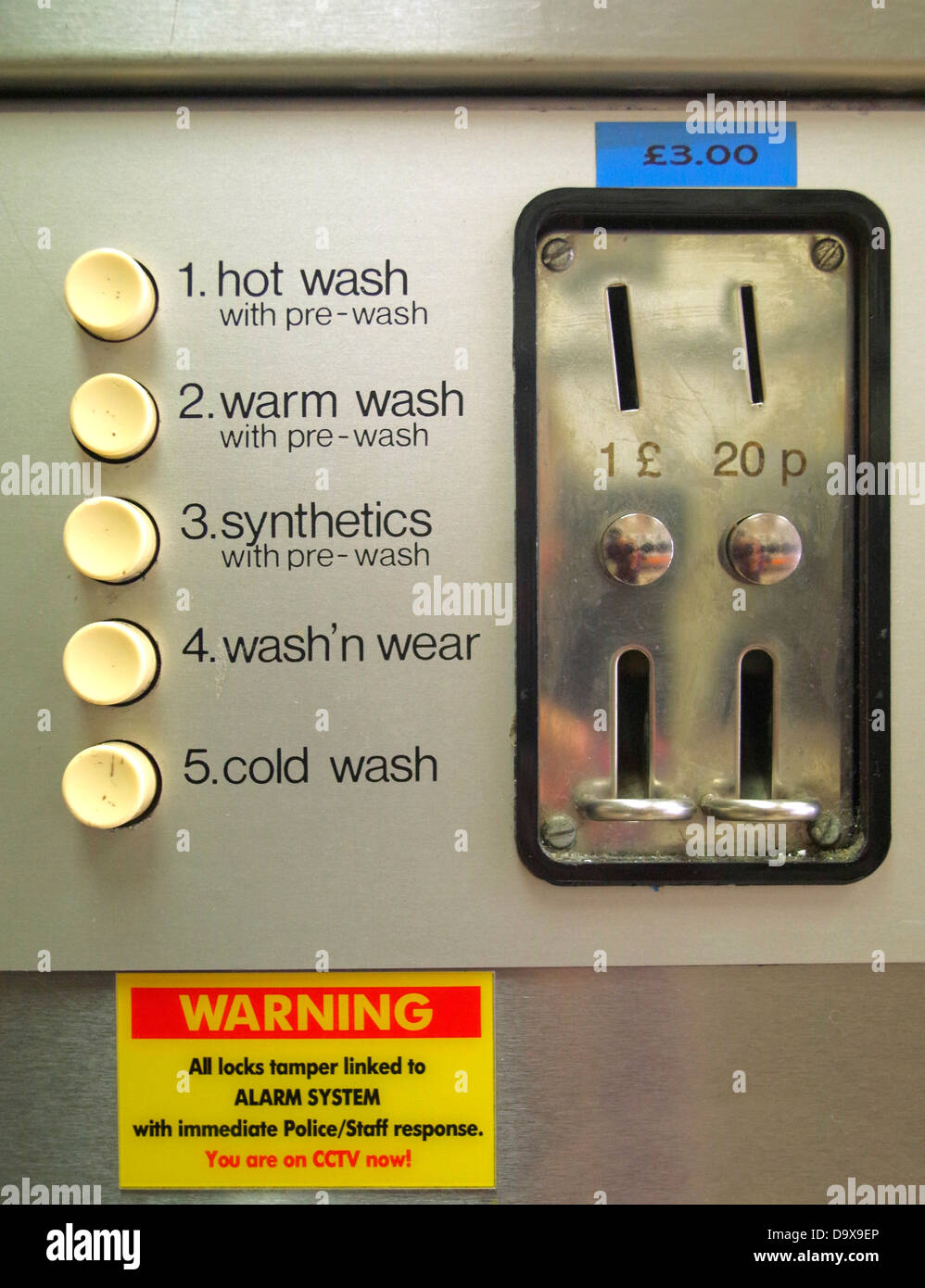 Coin slot on Laundrette washing machine Stock Photo