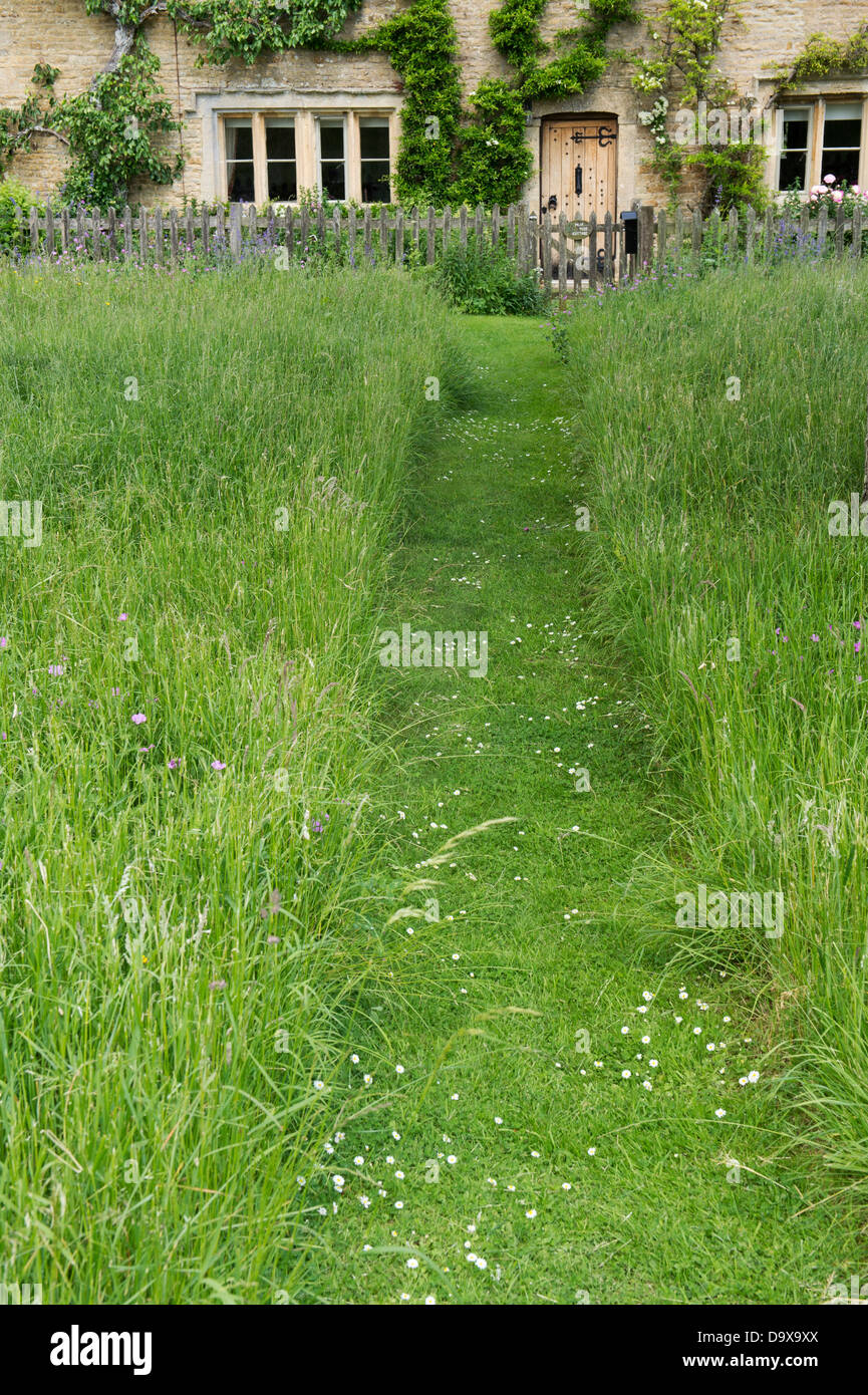 Mown Path Through Long Grass Leading Upto Cotswold Stone Cottage