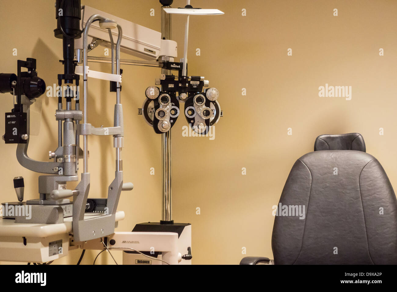A foreopter, slit lamp and patient chair in an exam room for eye care. Oklahoma City, Oklahoma, USA. Stock Photo