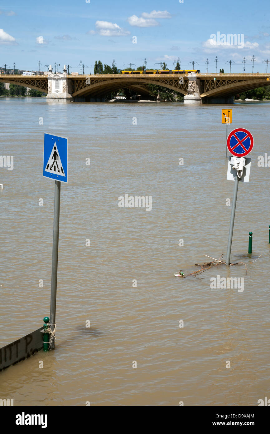 A road sign surrounded by water in a street flooded by the River Danube ...
