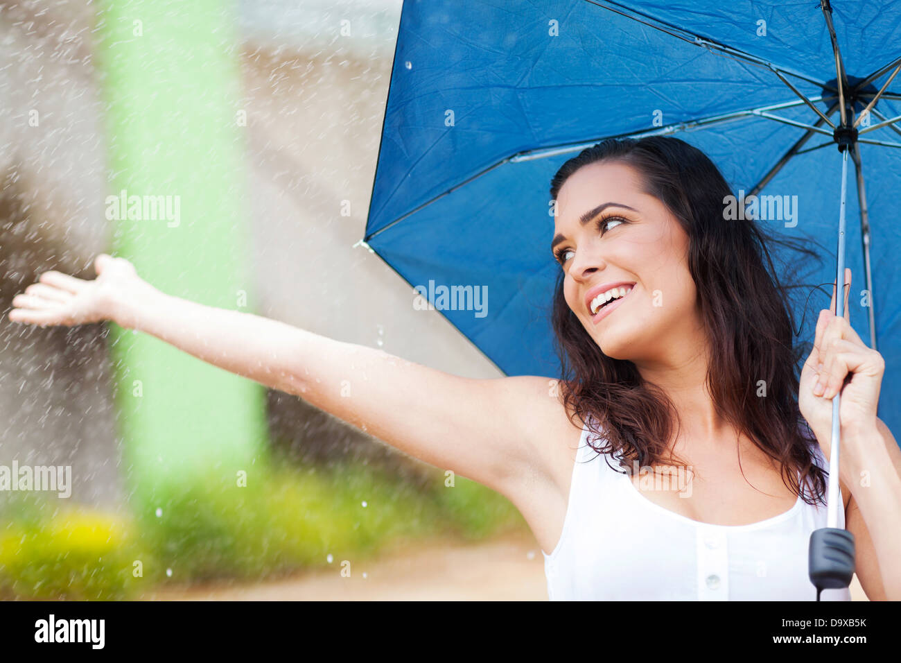 attractive young woman having fun in the rain Stock Photo