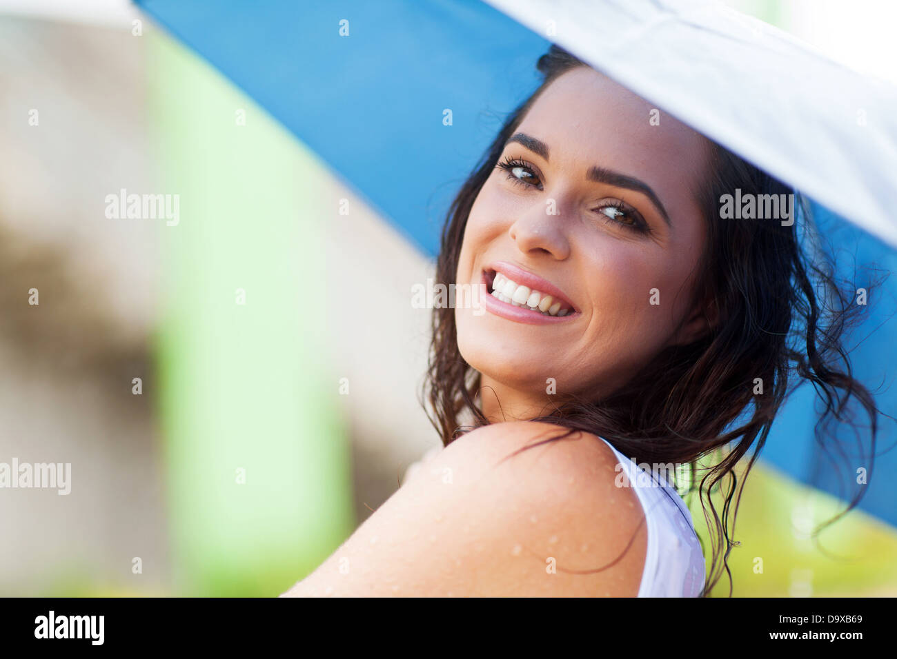 happy young woman holding umbrella in the rain Stock Photo