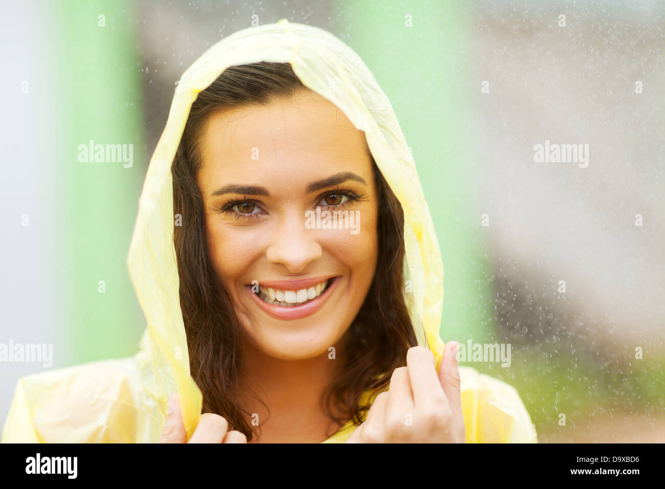 beautiful woman dress in raincoat in the rain Stock Photo