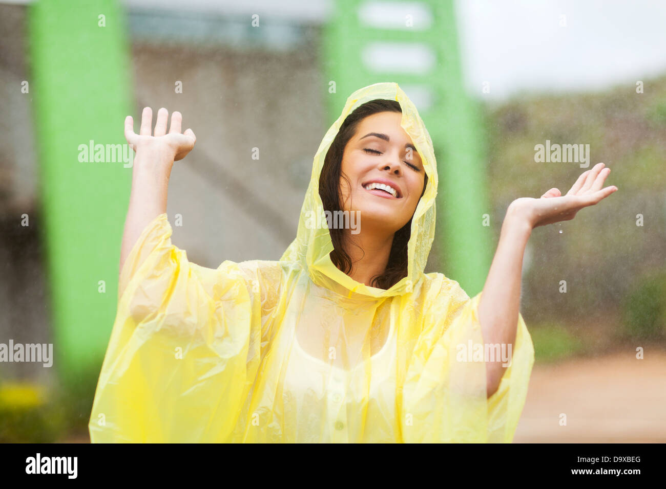 pretty young woman enjoying the rain outdoors Stock Photo