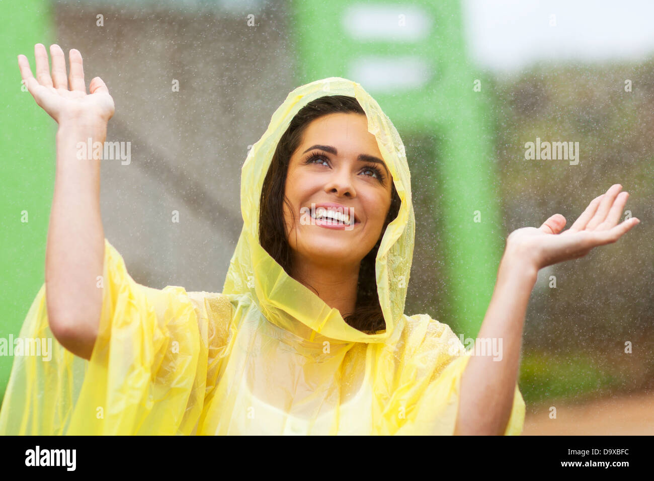 happy young woman playing in the rain Stock Photo