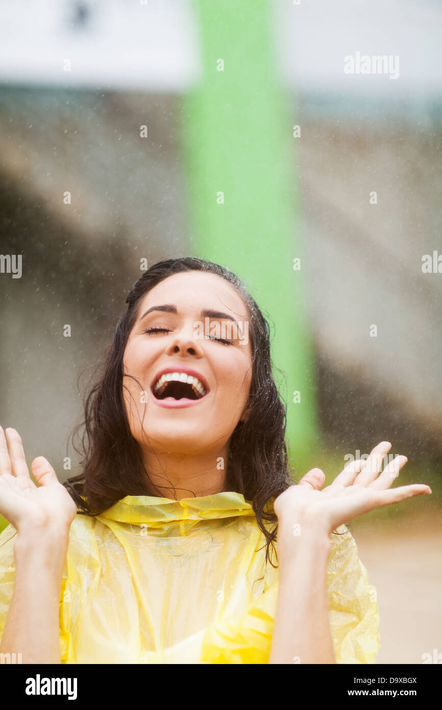 young woman having fun in the rain Stock Photo