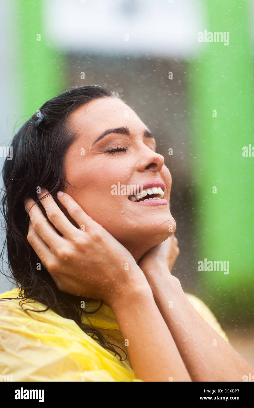 attractive young woman enjoying rain outdoors Stock Photo