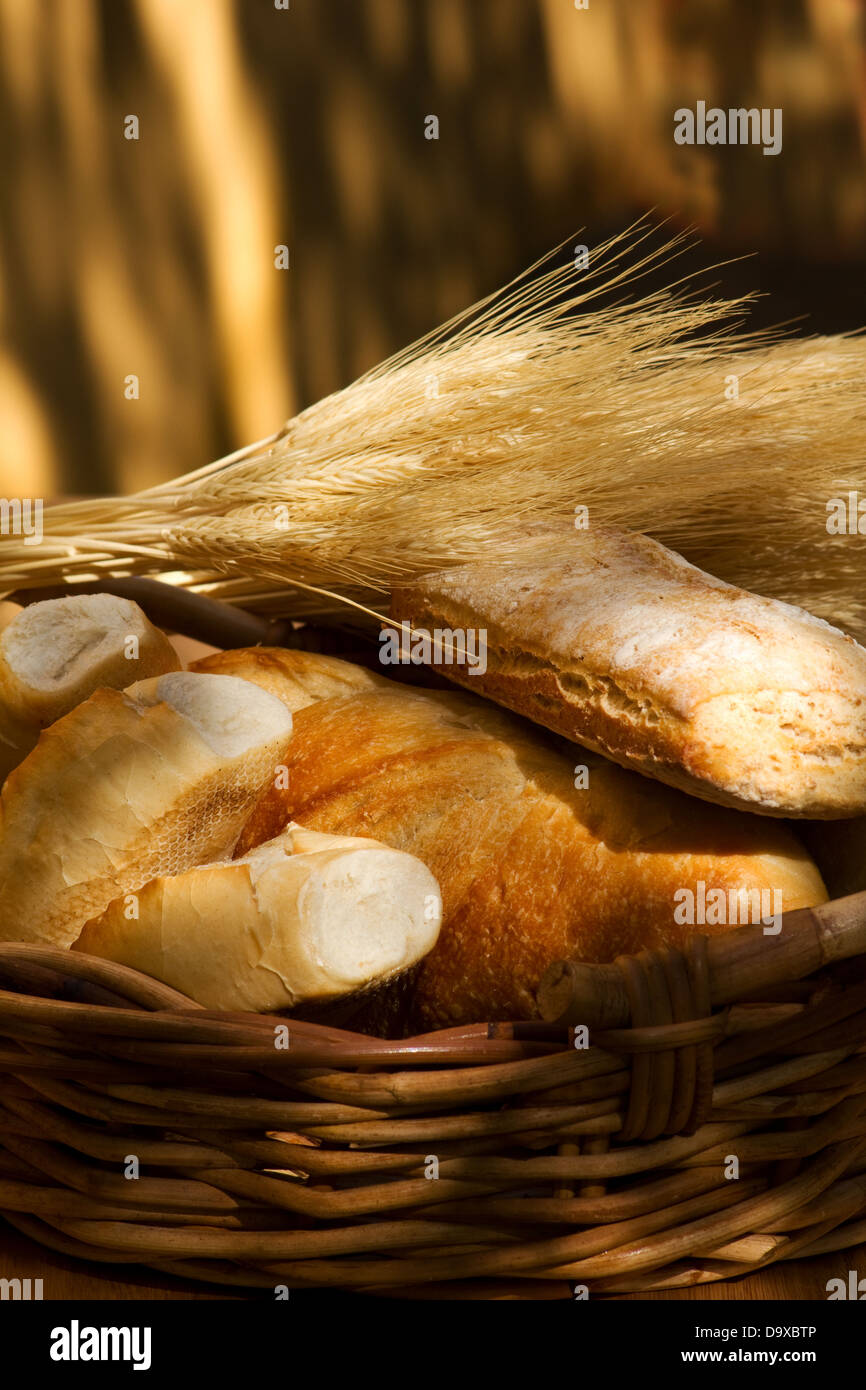 Basket with bread and wheat stalks Stock Photo