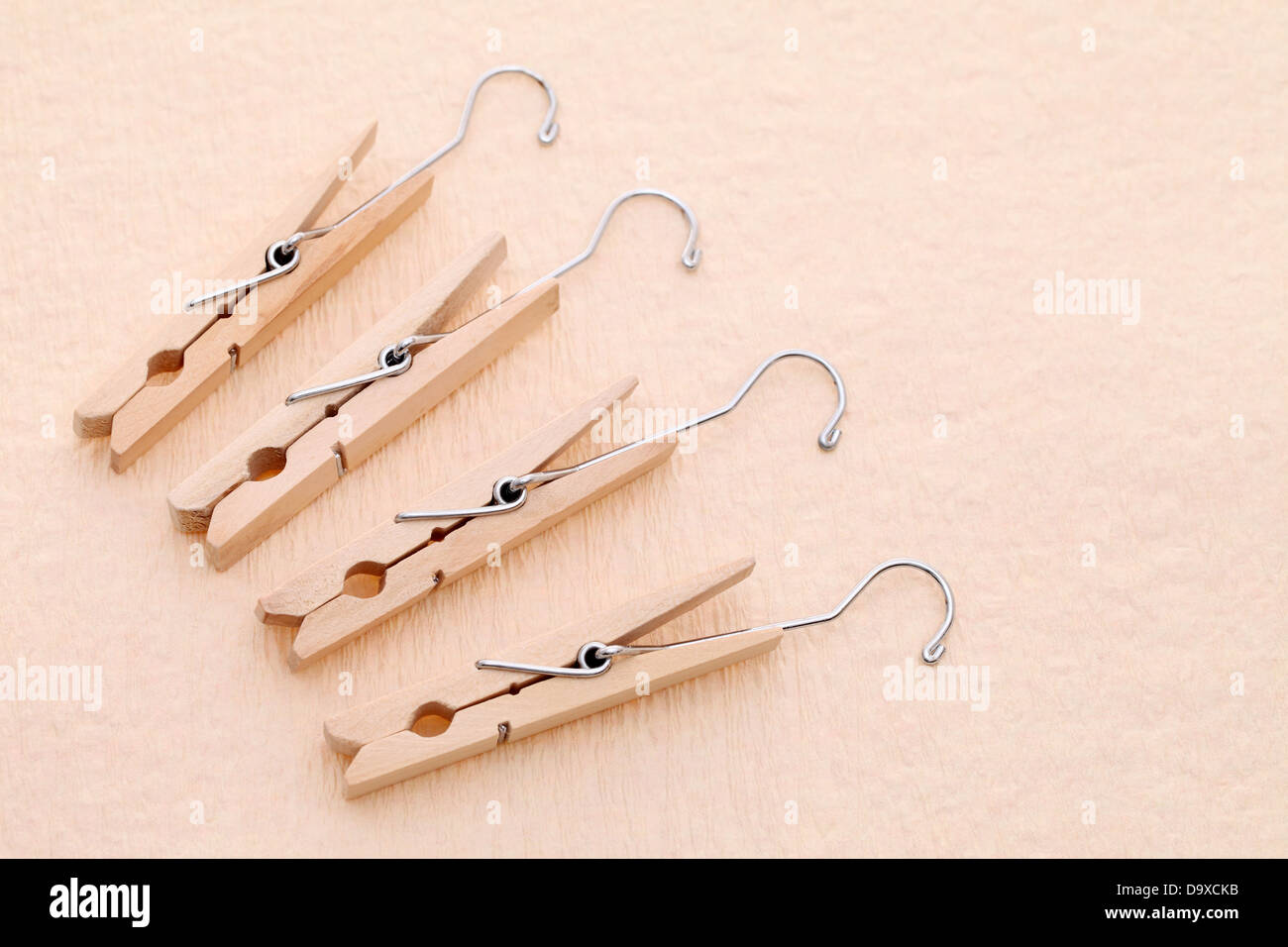 wooden clothespins with a metal hook on table Stock Photo Alamy