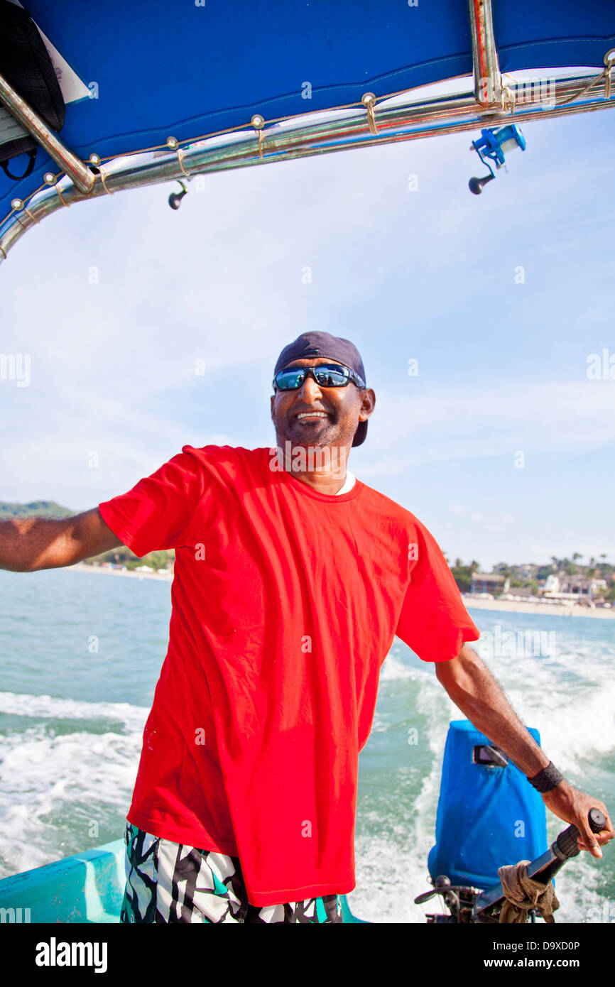 Man running fishing charter boat Stock Photo