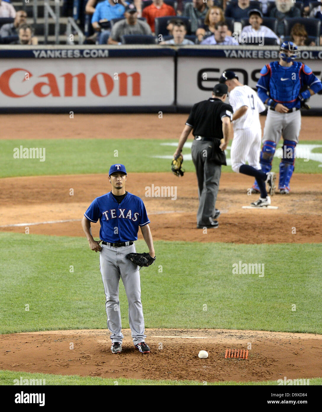 Yu Darvish (Rangers), JUNE 25, 2013 - MLB : Yu Darvish of the Texas Rangers reacts after giving up a home run to Brett Gardner of the New York Yankees, crossing home plate, in the fifth inning during the Major League Baseball game at Yankee Stadium in The Bronx, New York, United States. (Photo by AFLO) Stock Photo