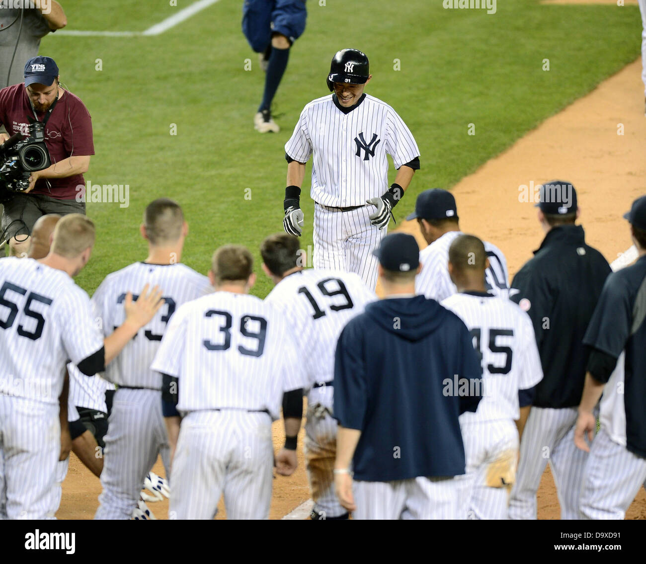 Ichiro Suzuki (Yankees), JUNE 25, 2013 - MLB : Ichiro Suzuki of the New York Yankees is greeted by his teammates at home plate after hitting a walk off home run in the ninth inning during the Major League Baseball game against the Texas Rangers at Yankee Stadium in The Bronx, New York, United States. (Photo by AFLO) Stock Photo