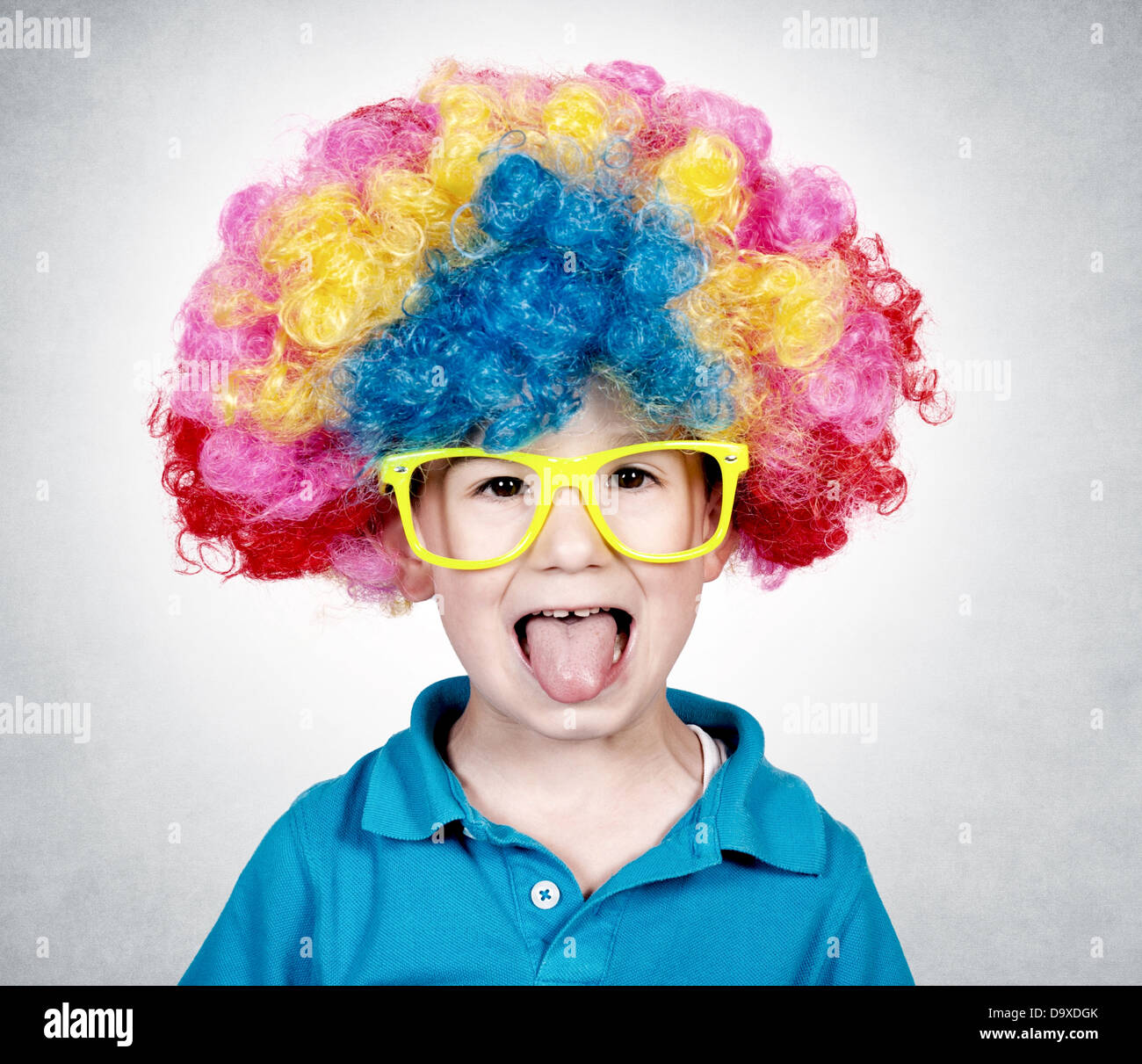 Little boy wearing clown wig and mocks Stock Photo