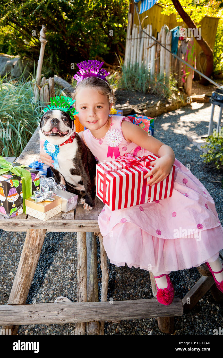 Young girl and dog at outdoor birthday paty Stock Photo