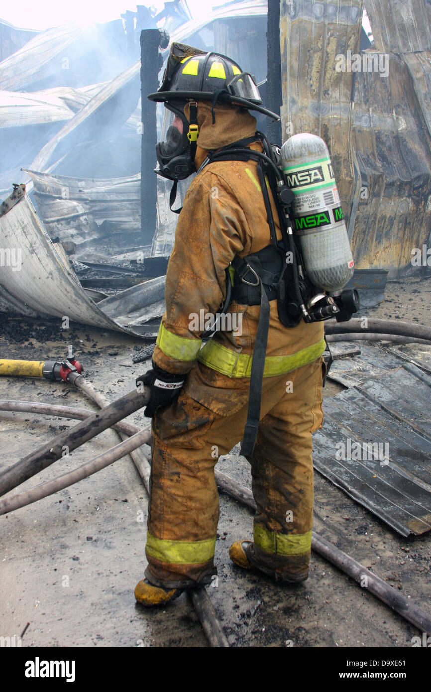 A woman firefighter working on a fire scene in Wisconsin Stock Photo