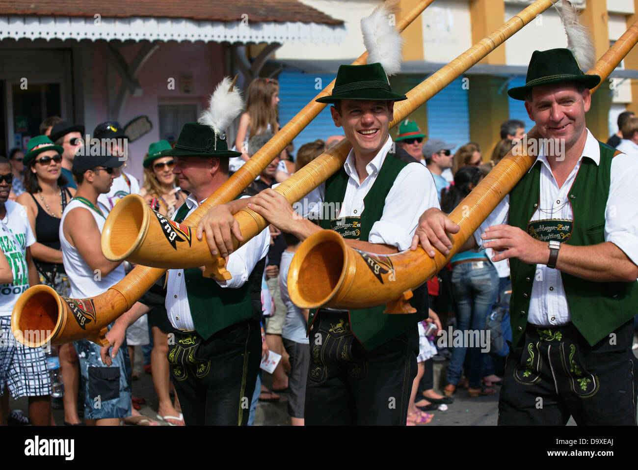 Bavarian guest musicians carrying their Alphorn instruments during the Oktoberfest parade Stock Photo