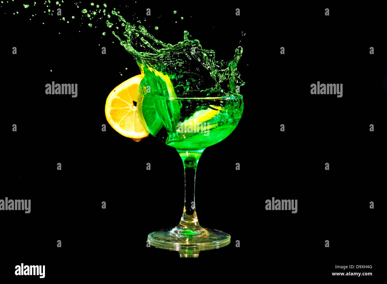 Green cocktail splash with a slice of citron Stock Photo