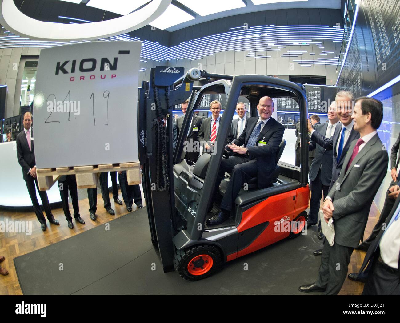 Gordon Riske (C), head of German multinational manufacturer of forklifts Kion, poses for the