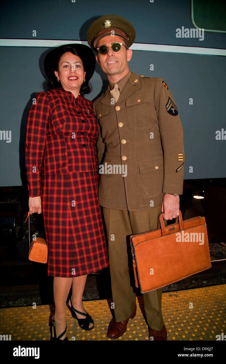1940's Serviceman and wife pose in front of Pearl Harbor Day Troop train reenactment from Los Angeles Union Station to San Diego Stock Photo