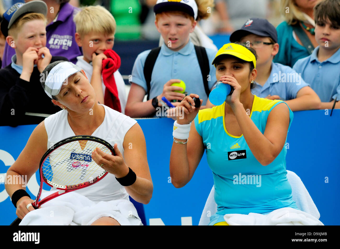 Sania Mirza (India) and Liezel Huber (USA) playing doubles. Children watching at Eastbourne, 2013 Stock Photo