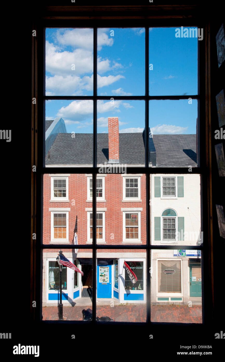 Through interior window pains, storefronts line Water Street in