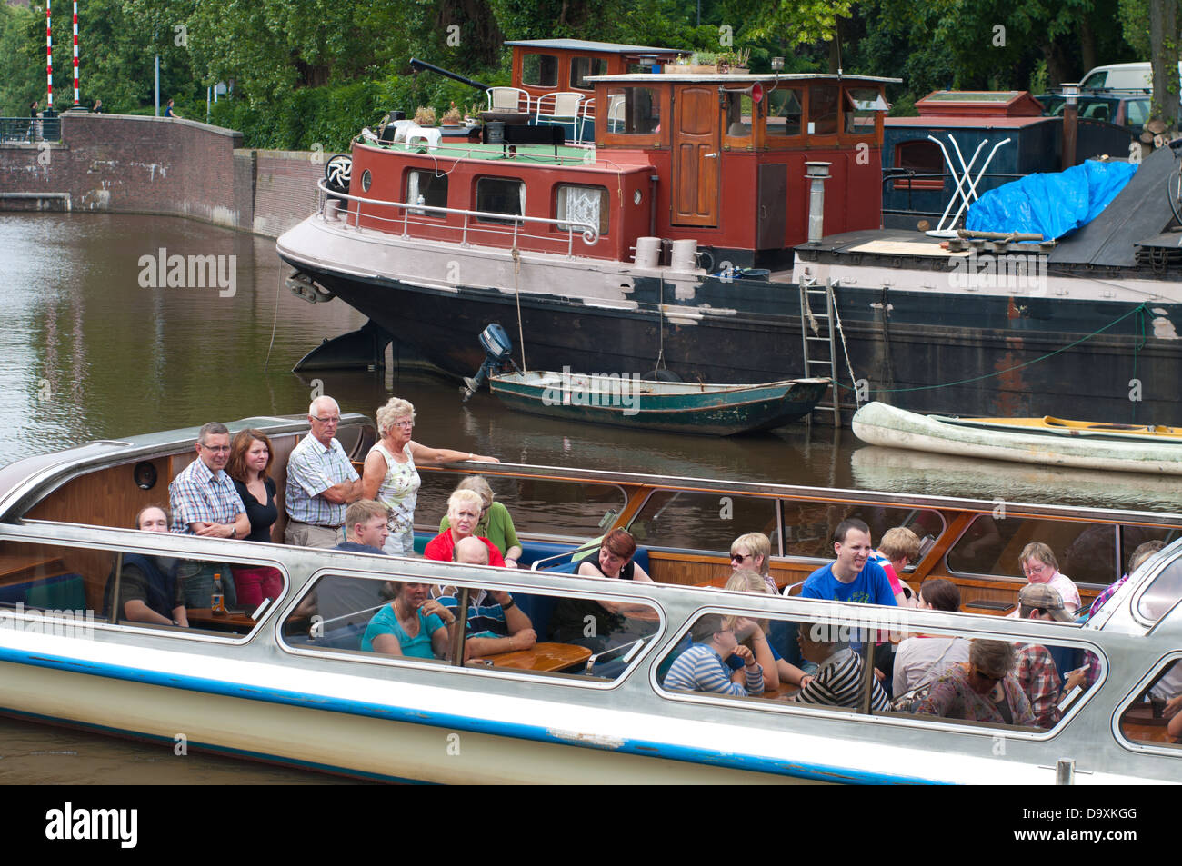 tourists in an open sightseeing boat in Groningen, netherlands Stock Photo