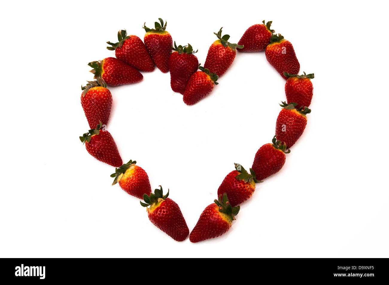 fresh strawberries in heart shape on a white background Stock Photo