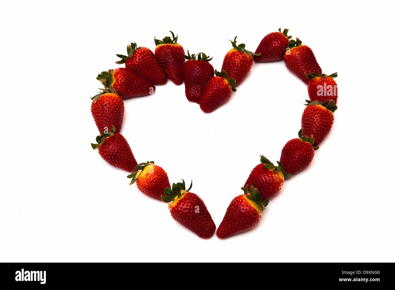 fresh strawberries in heart shape on a white background Stock Photo