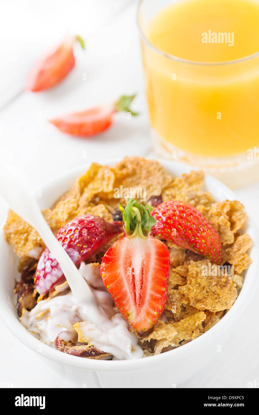 Healthy breakfast with whole grain cereal with milk, fresh strawberry