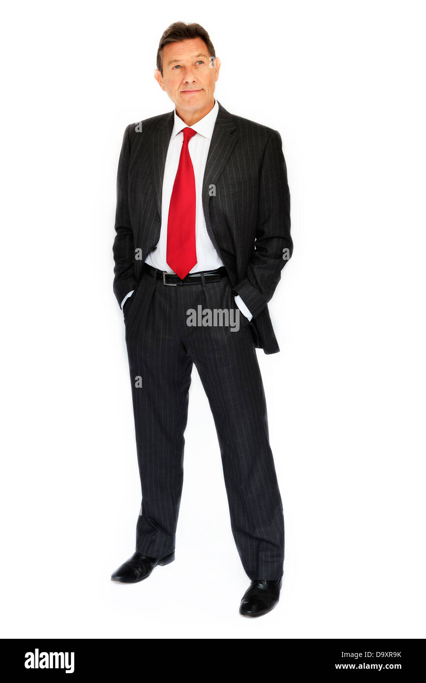 Full length portrait of a business man wearing a suit, shirt and tie. Hands in pockets. Stock Photo