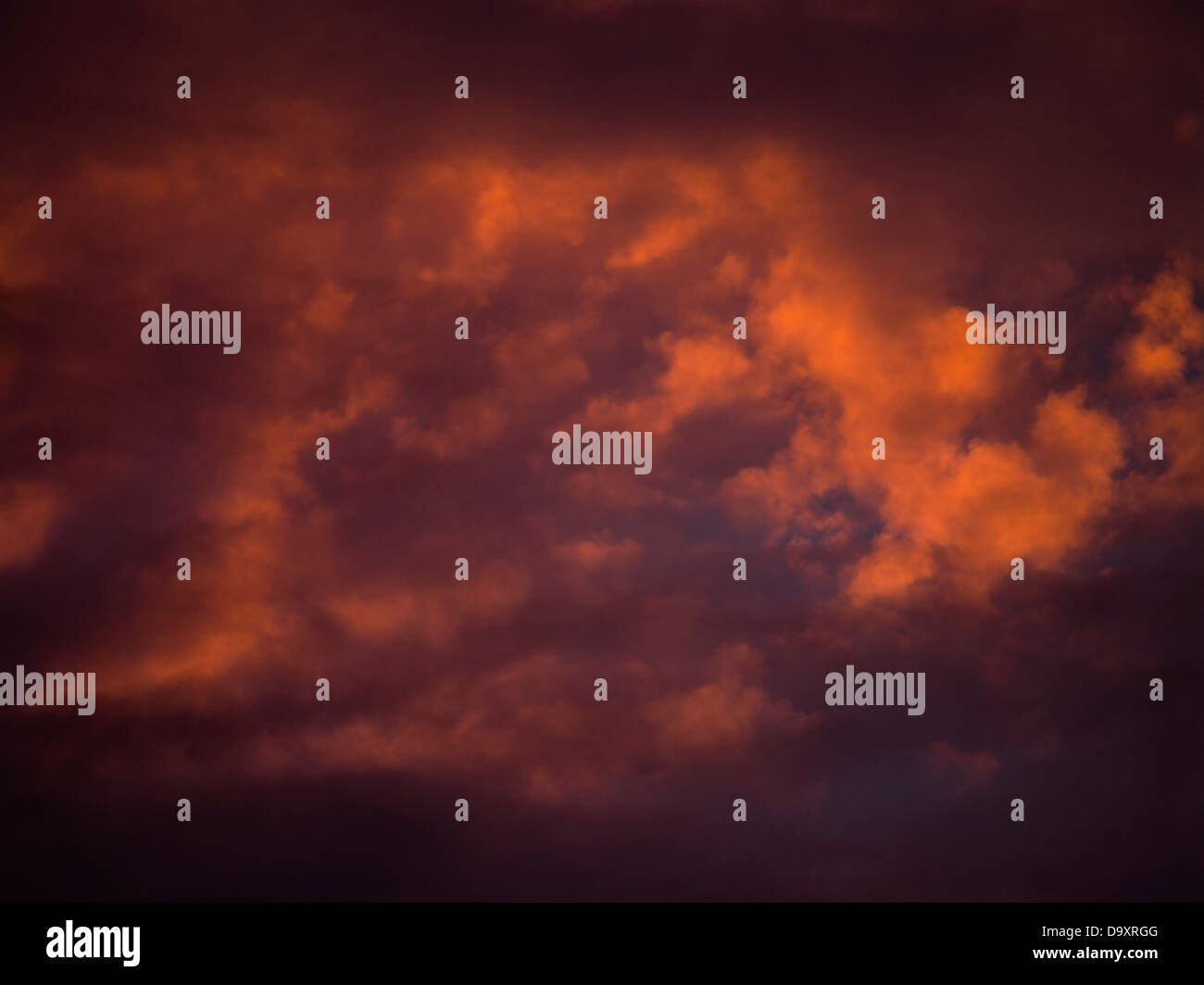 dh Evening cloud SKY WEATHER Red orange dark storm clouds black skies above sunset stormy background atmospheric atmosphere Stock Photo