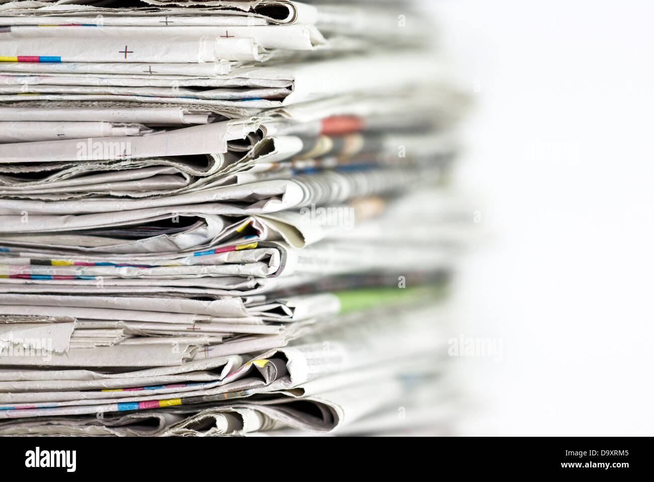 Pile of newspapers on white background Stock Photo