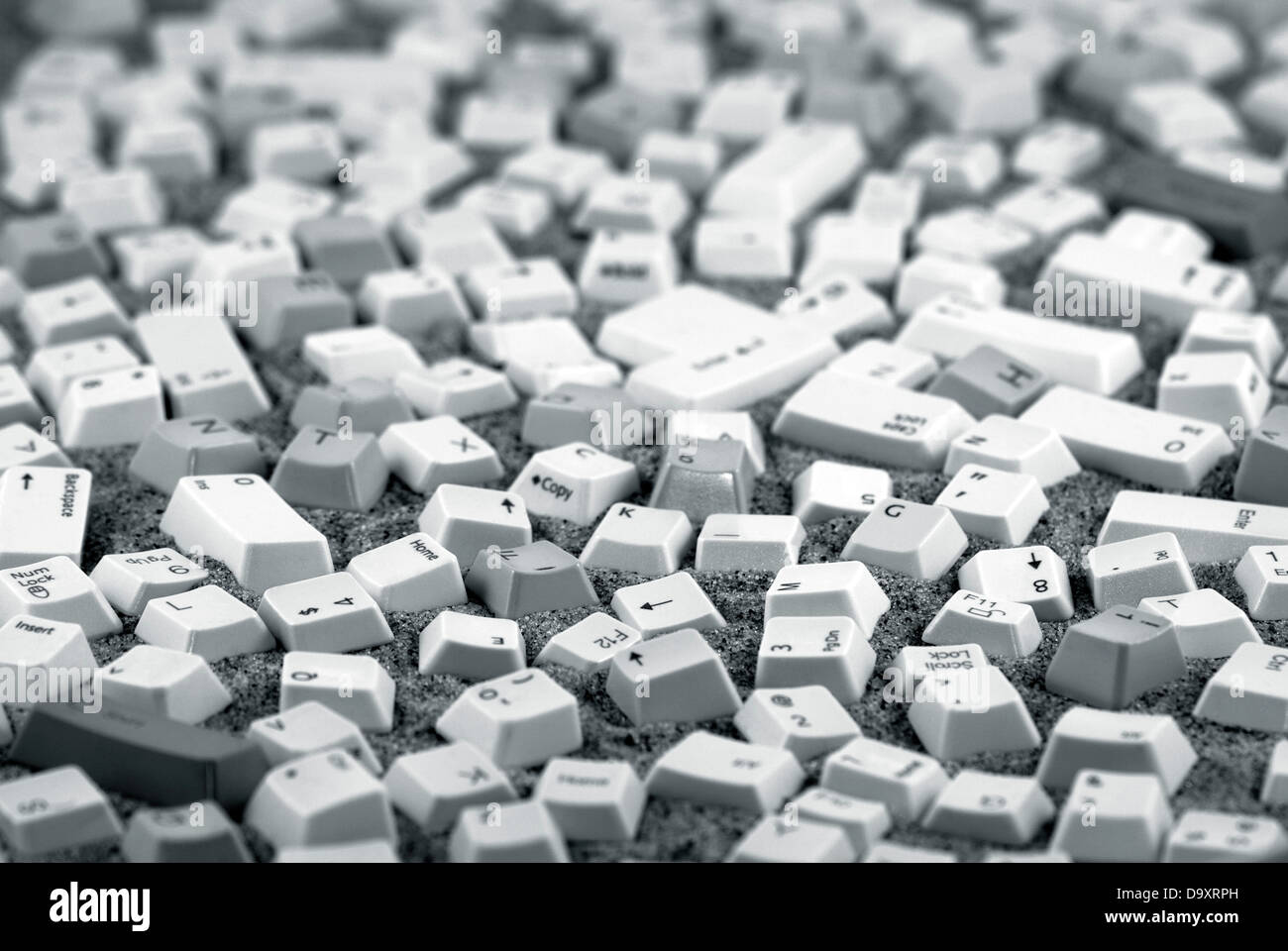 Computer keys over sand Stock Photo